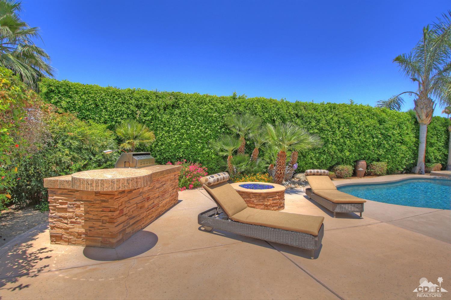 4 Mesquite Ridge Lane Rancho Mirage, CA 92270 - Photo 51 of 62 a view of a swimming pool with a patio