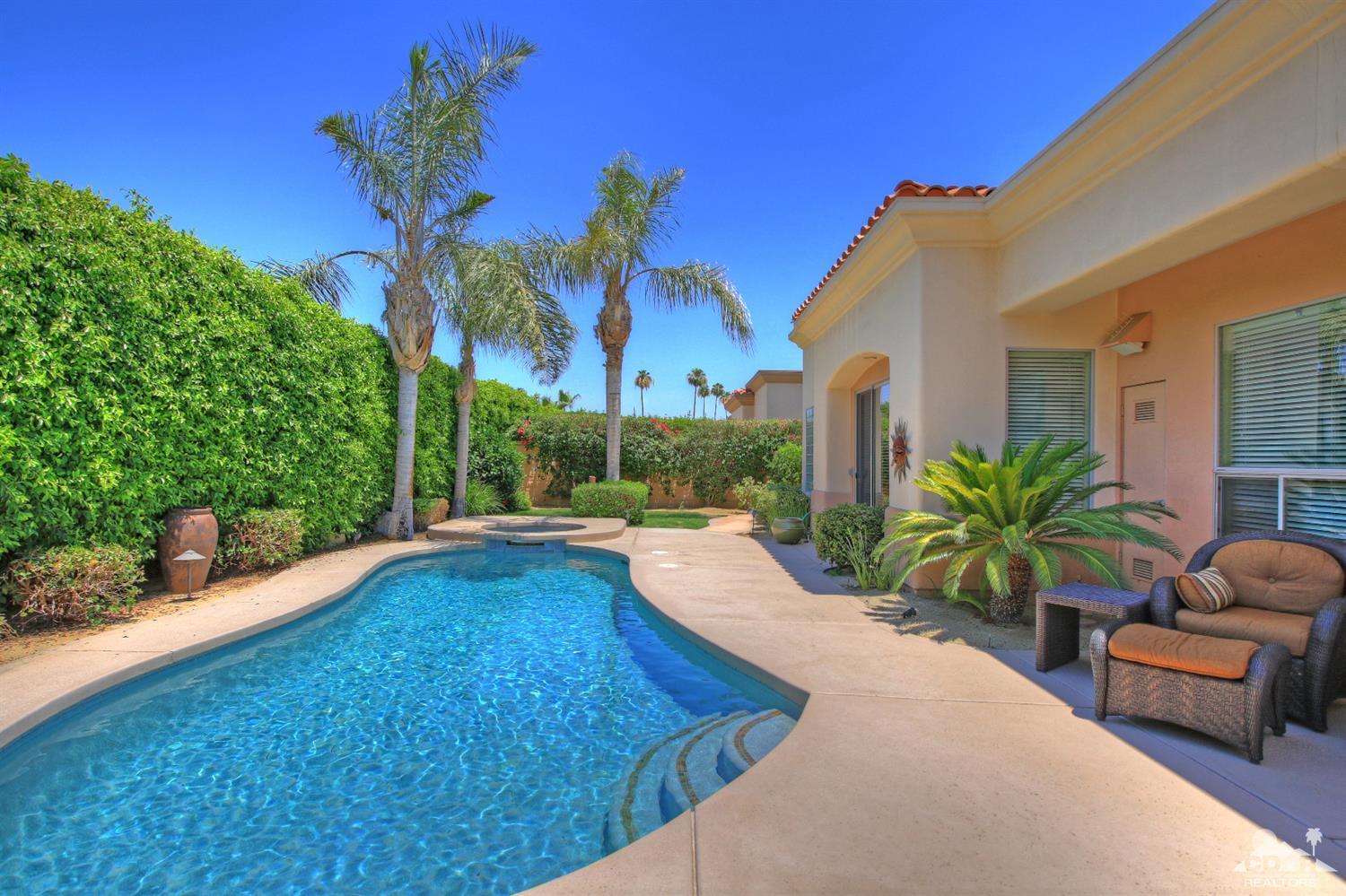 4 Mesquite Ridge Lane Rancho Mirage, CA 92270 - Photo 53 of 62 a house with palm tree in front of it