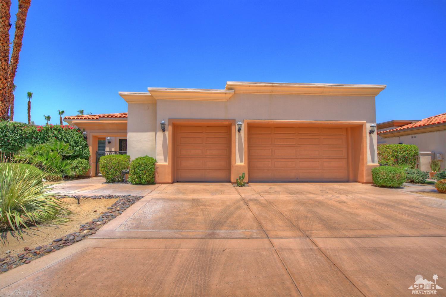 4 Mesquite Ridge Lane Rancho Mirage, CA 92270 - Photo 59 of 62 a front view of a house with a yard and garage
