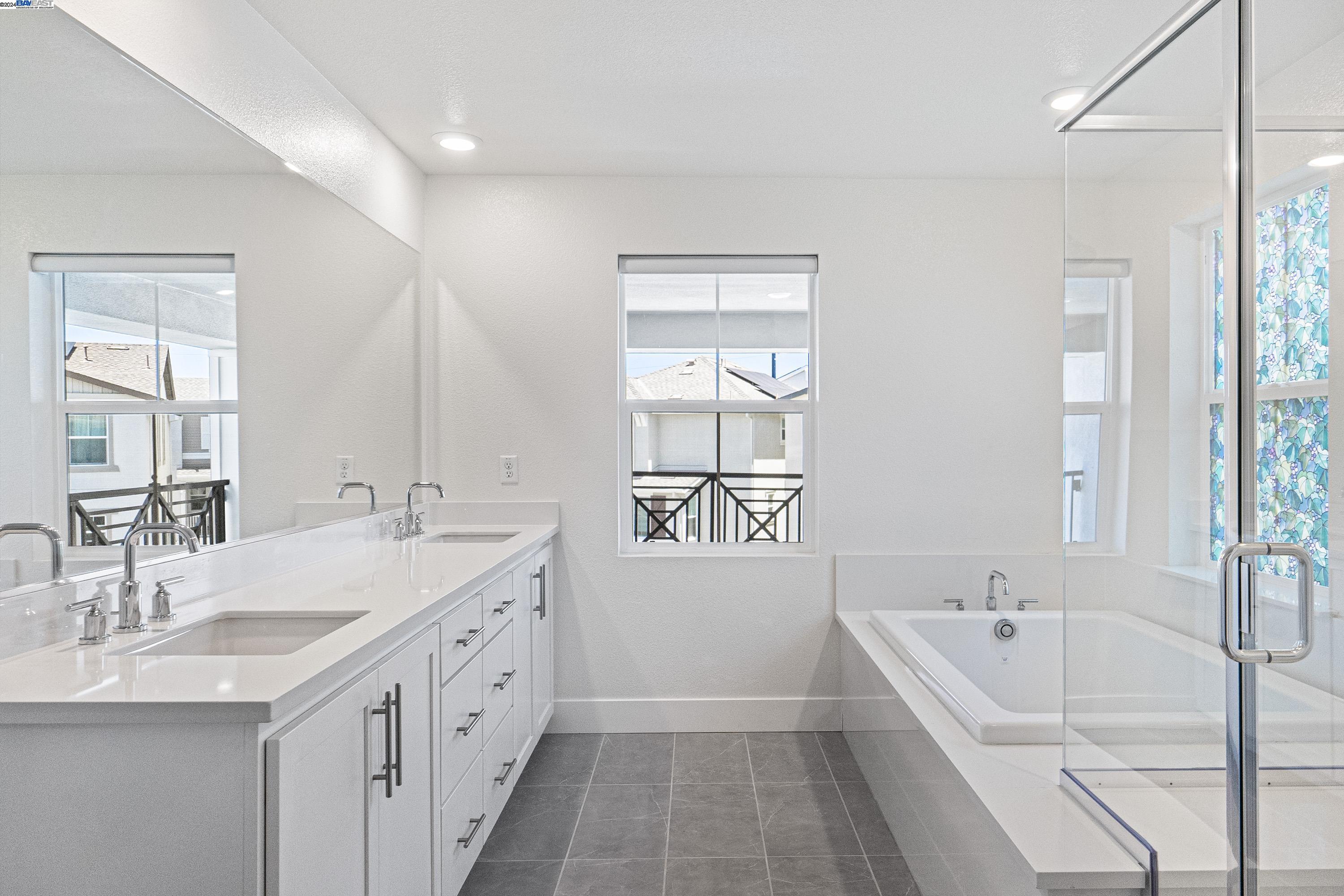 9657 Pontoon Way Newark, CA 94560 - Photo 13 of 46 a bathroom with a tub sink and mirror