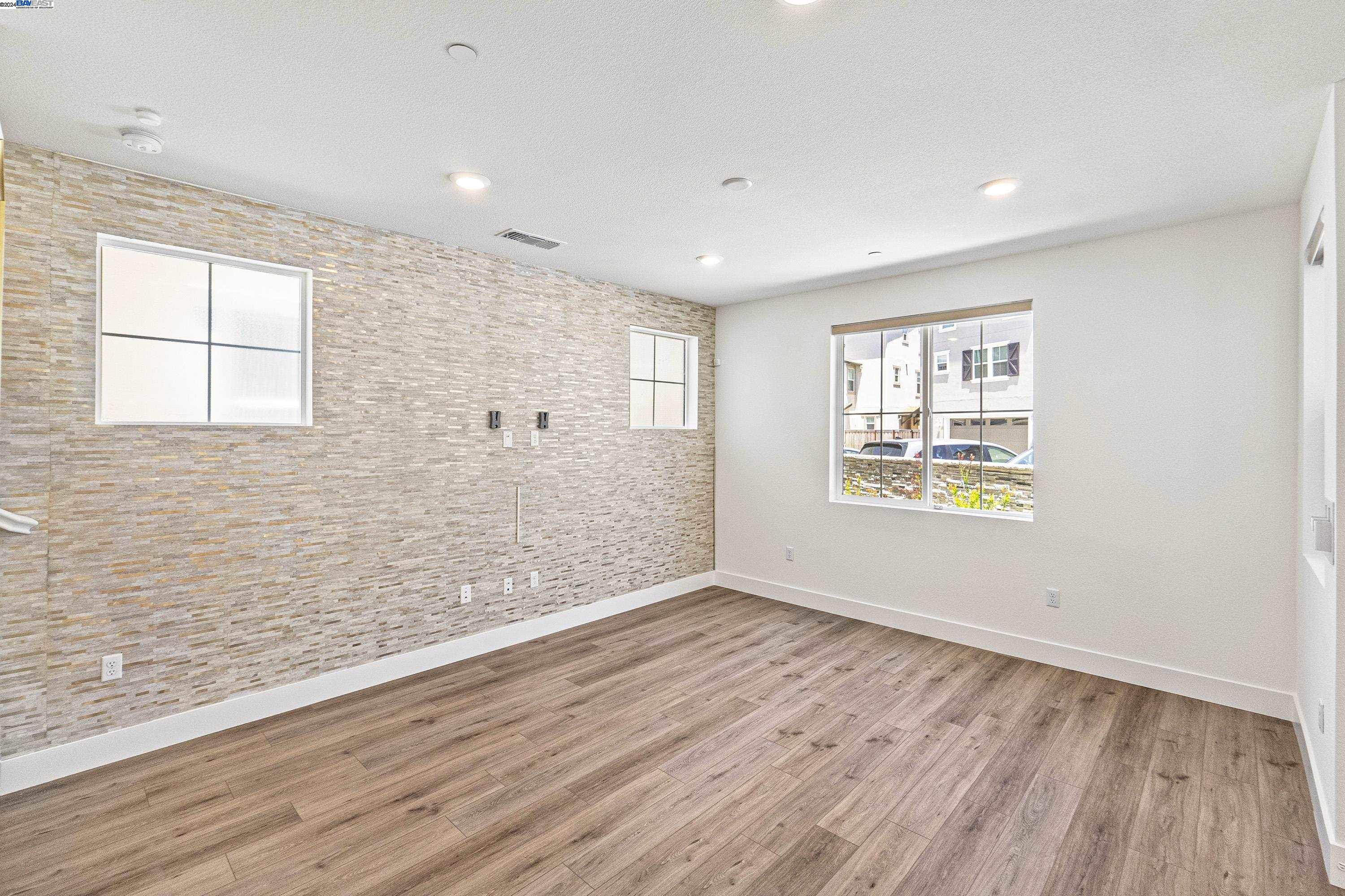 9657 Pontoon Way Newark, CA 94560 - Photo 3 of 46 an empty room with wooden floor and windows