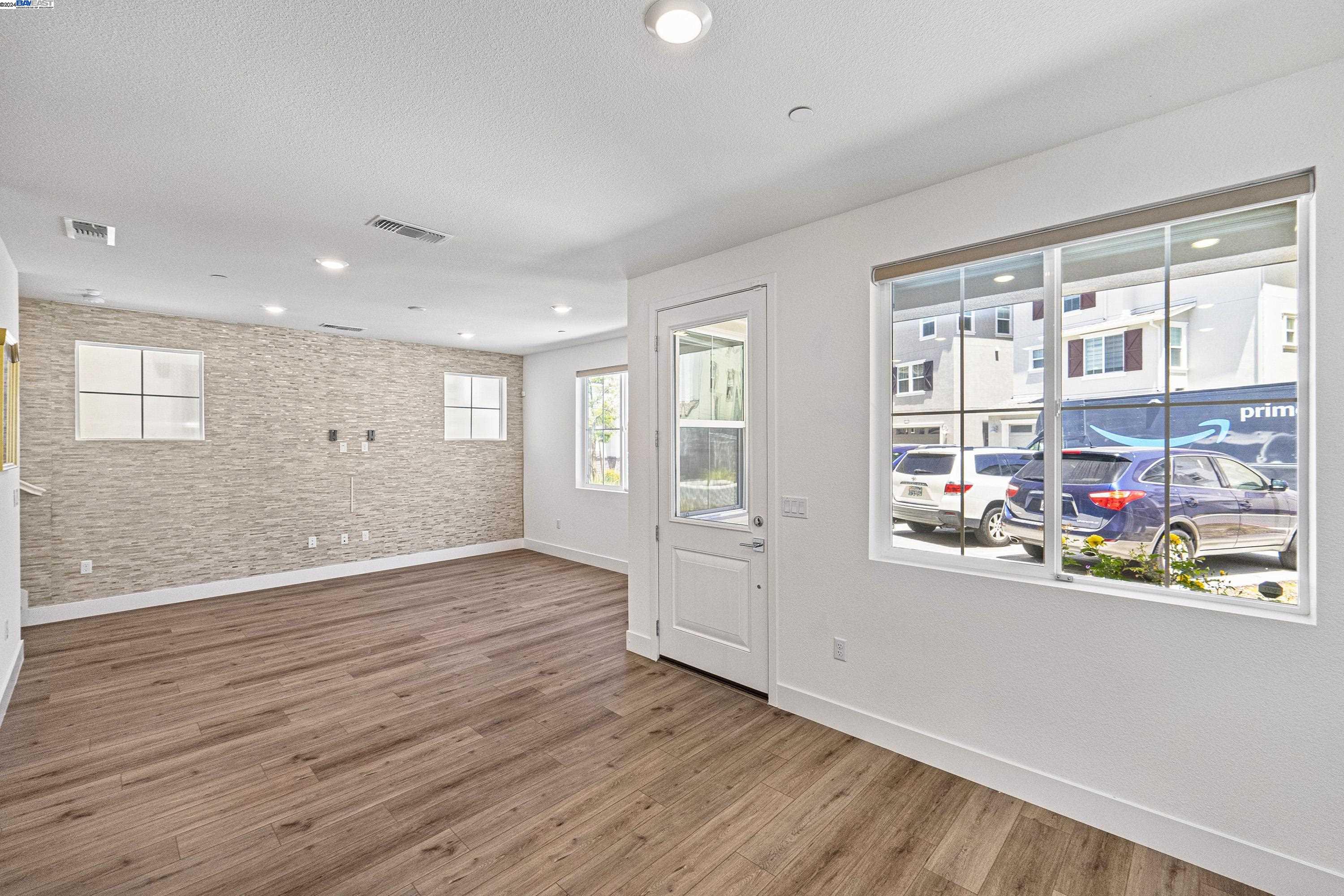 9657 Pontoon Way Newark, CA 94560 - Photo 7 of 46 a view of an empty room with wooden floor and natural light