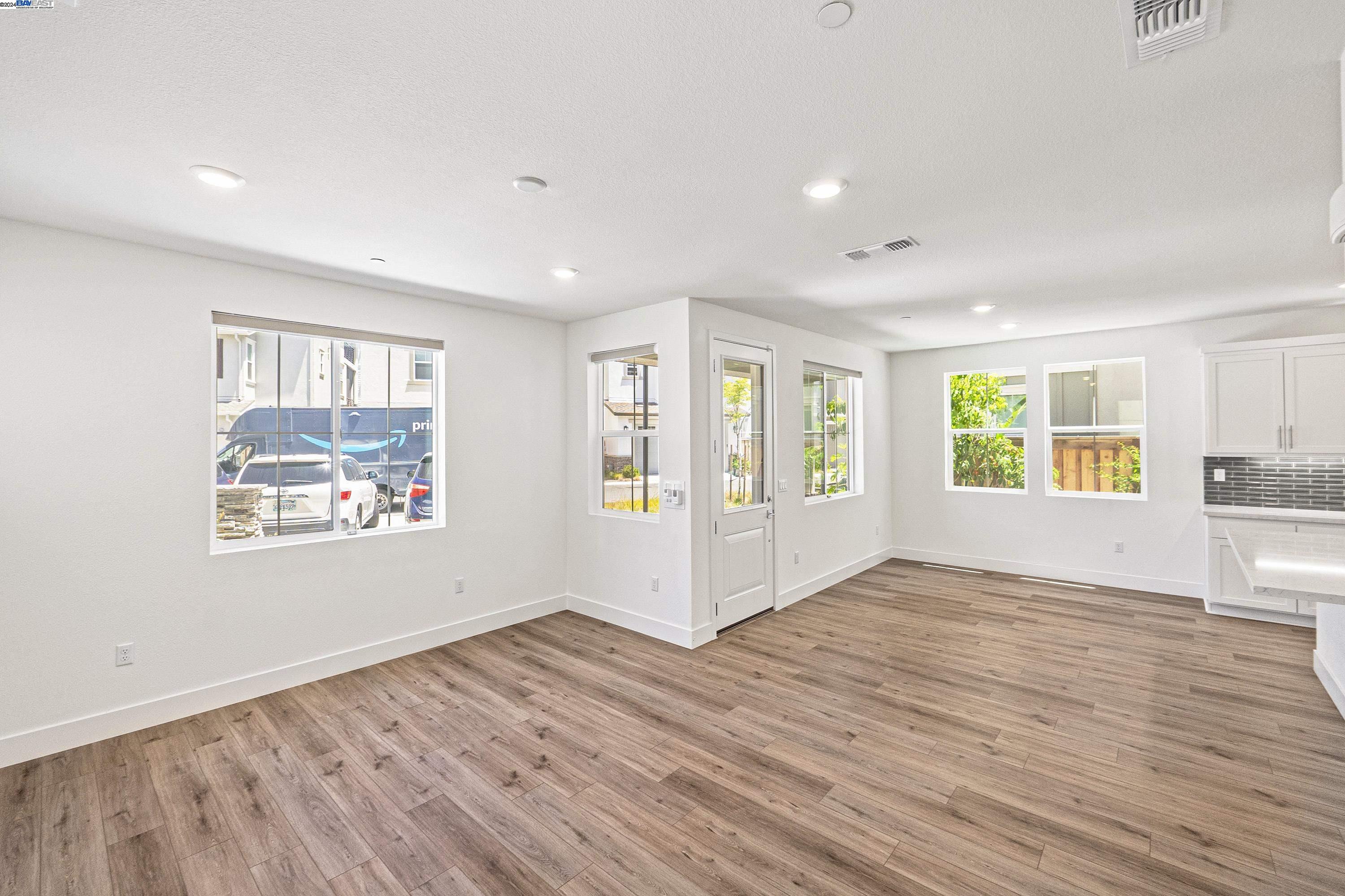 9657 Pontoon Way Newark, CA 94560 - Photo 9 of 46 a view of an empty room with a window and wooden floor