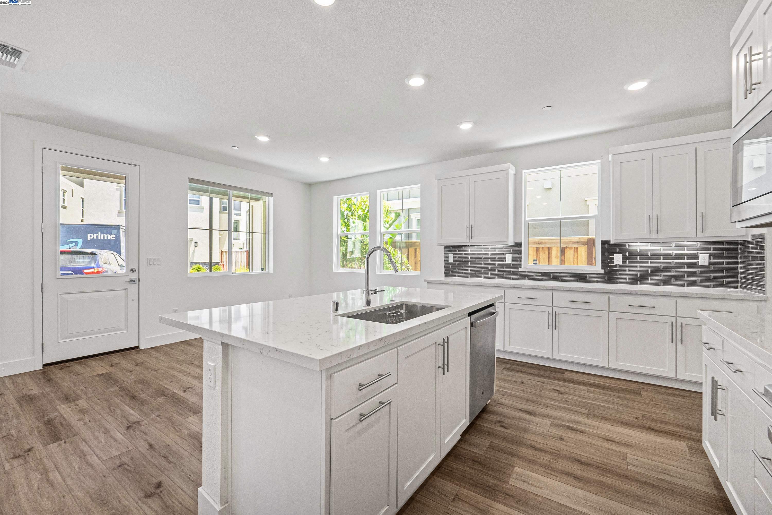 9657 Pontoon Way Newark, CA 94560 - Photo 10 of 46 a kitchen with a sink window and cabinets