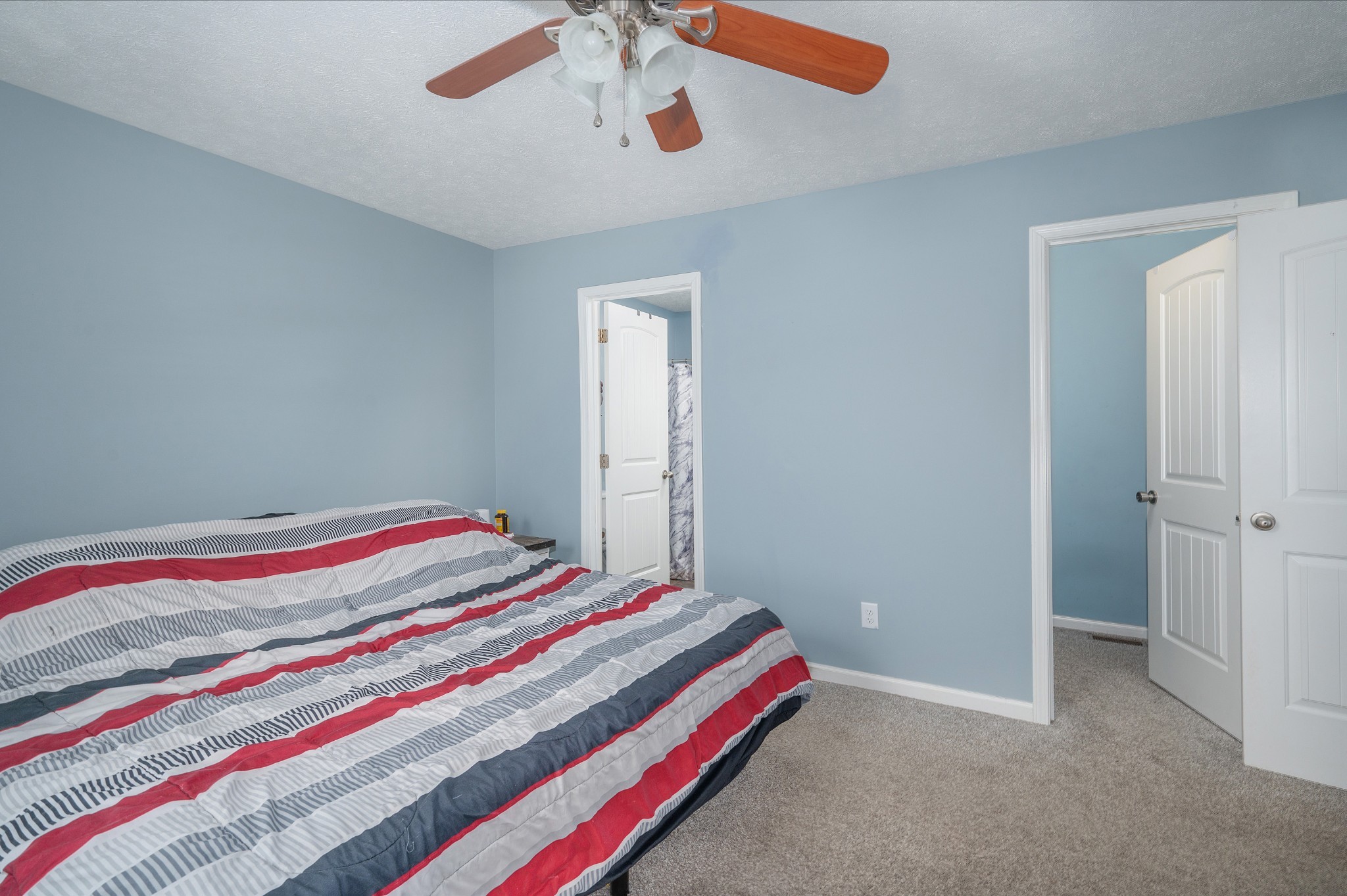 2995 Oak Grove Church Road Bethpage, TN 37022 - Photo 13 of 28 a bedroom with a bed and a chandelier