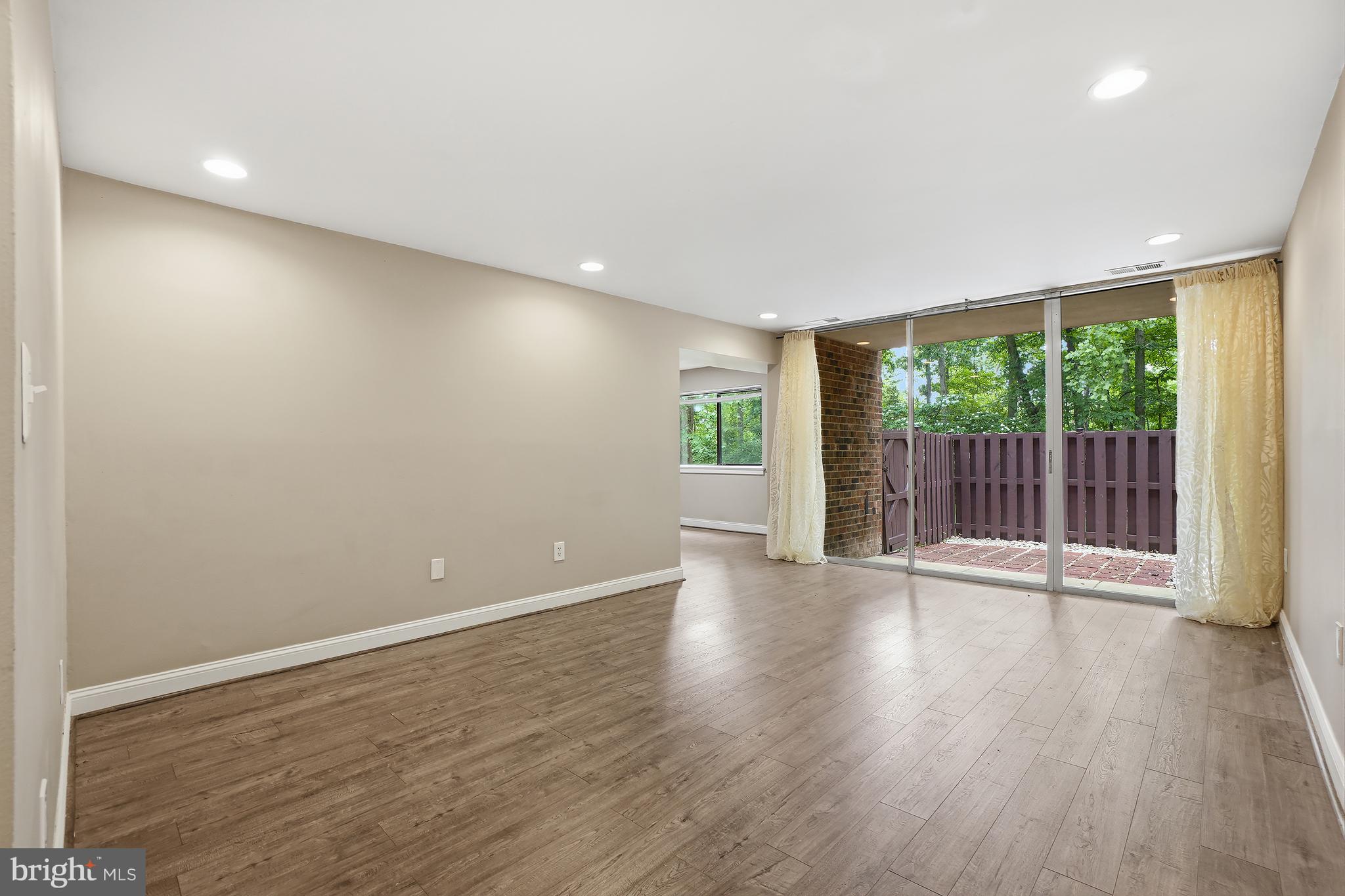 8487 Greenbelt Road Greenbelt, MD 20770 - Photo 3 of 29 a view of an empty room with wooden floor and a window