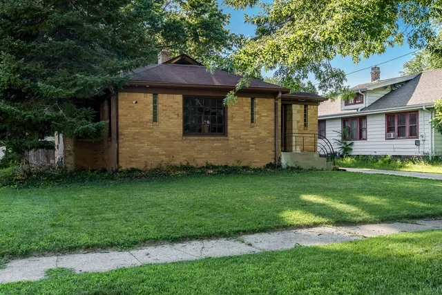 a front view of a house with a garden