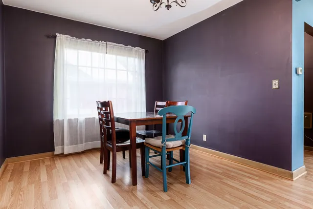 a dining room with furniture and wooden floor