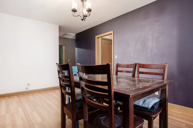 a dining room with furniture and wooden floor
