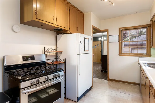 a kitchen with stainless steel appliances granite countertop a refrigerator and a stove top oven