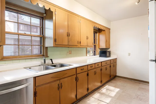 a kitchen with sink and cabinets