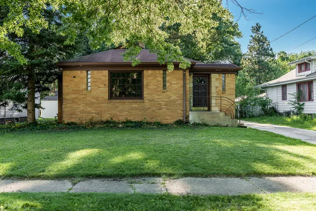 a front view of a house with a garden