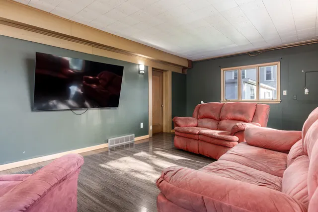 a living room with couches and a flat screen tv