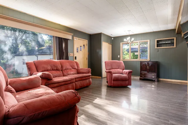 a living room with furniture and large windows