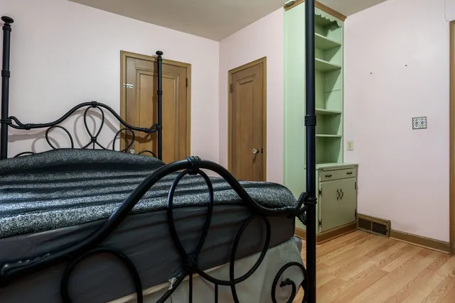 a bedroom with a bed and a chandelier