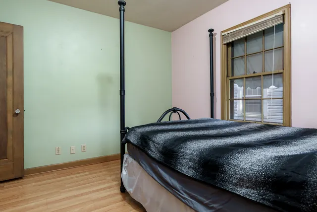 a bedroom with a bed and a window