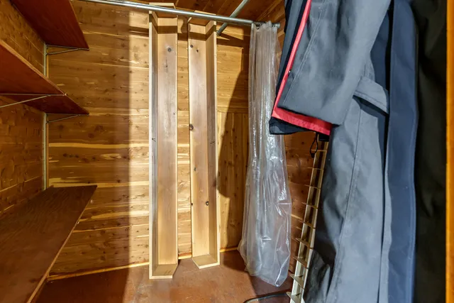 a view of walk in closet with clothes