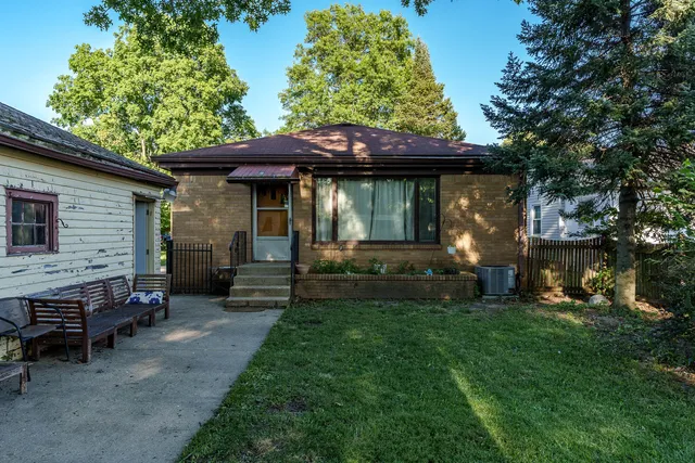 a view of a house with a bed and a table