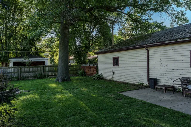 a view of backyard of house with green space