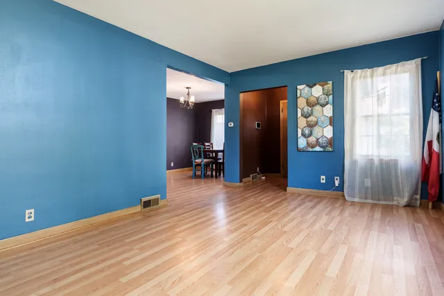 a view of a room with wooden floor and windows