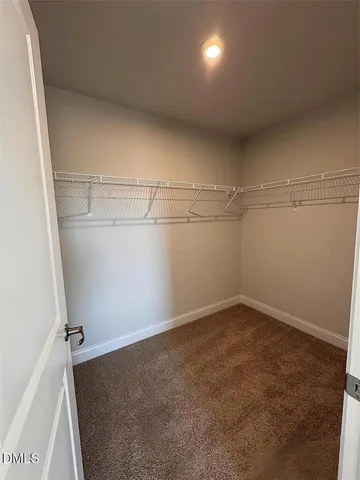a spacious bathroom with a vanity sink and a mirror