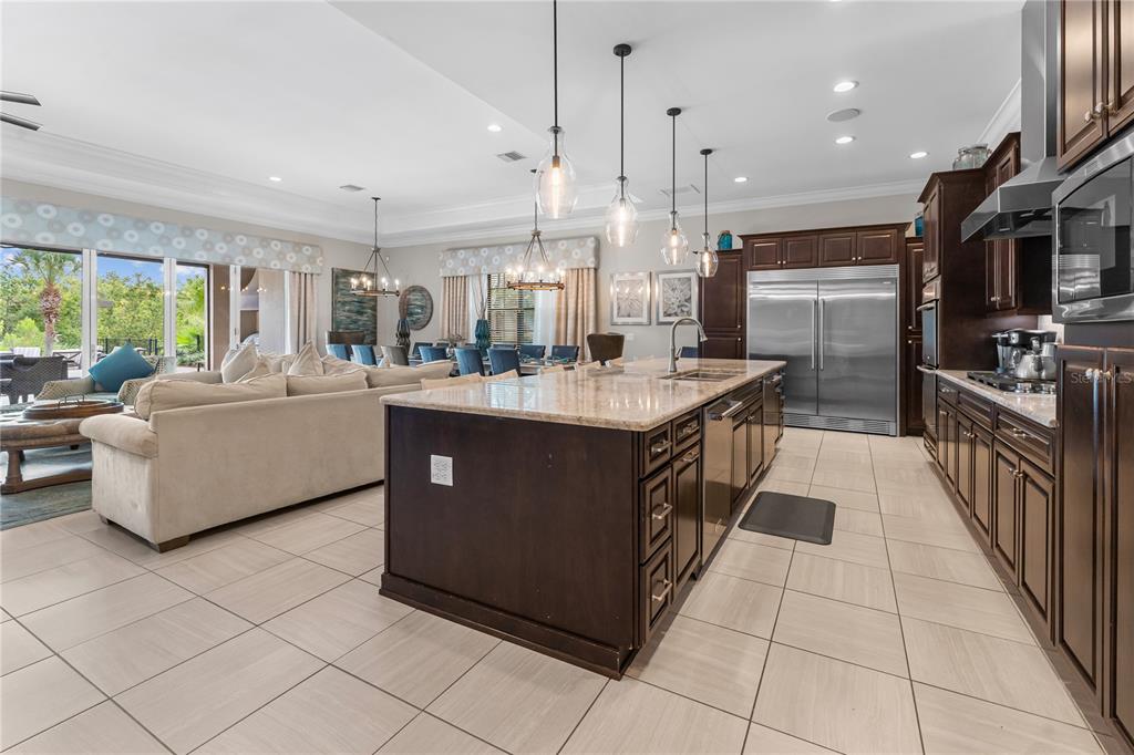 600 Muirfield Loop Reunion, FL 34747 - Photo 14 of 95 a large kitchen with stainless steel appliances granite countertop a sink and cabinets