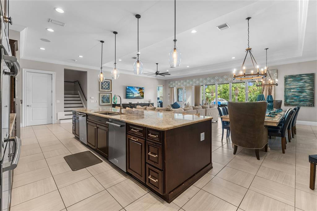 600 Muirfield Loop Reunion, FL 34747 - Photo 22 of 95 a kitchen with kitchen island granite countertop a sink a counter top space and stainless steel appliances