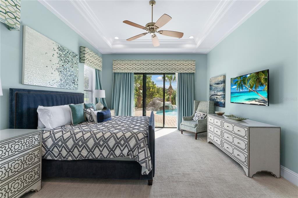 600 Muirfield Loop Reunion, FL 34747 - Photo 24 of 95 a bedroom with a bed and a flat screen tv