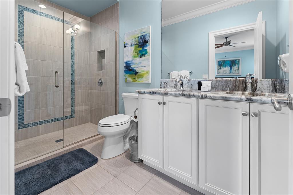 600 Muirfield Loop Reunion, FL 34747 - Photo 55 of 95 a bathroom with a granite countertop sink a toilet and shower