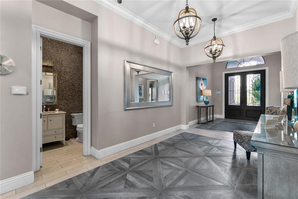 600 Muirfield Loop Reunion, FL 34747 - Photo 8 of 95 a view of an dining room with furniture wooden floor and a chandelier