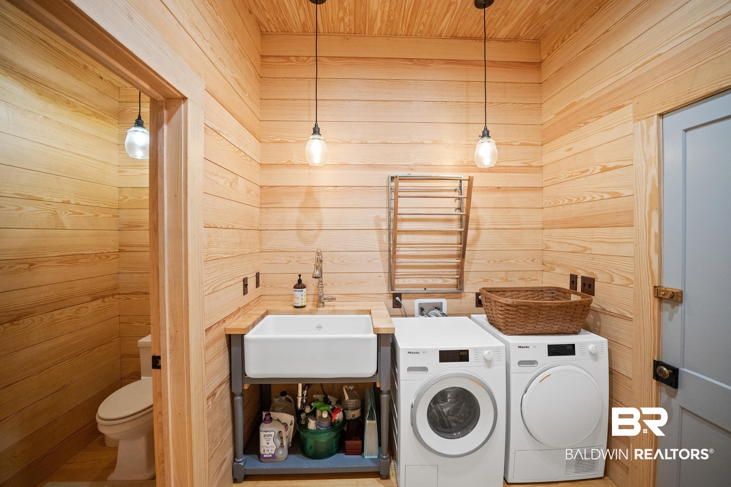 30671 Magnolia Street Elberta, AL 36530 - Photo 50 of 68 Laundry area featuring washing machine and dryer, wood ceiling, a sink, wood walls, and laundry area