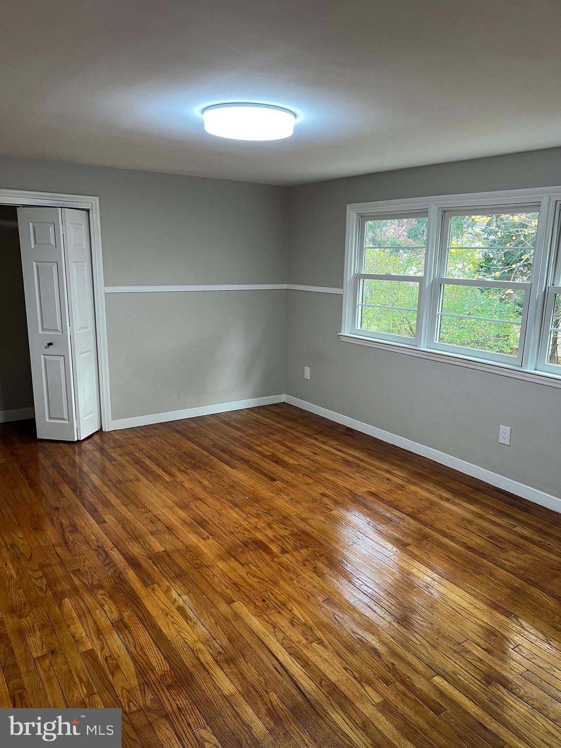 202 Museum Road Shillington, PA 19607 - Photo 19 of 29 an empty room with wooden floor and windows