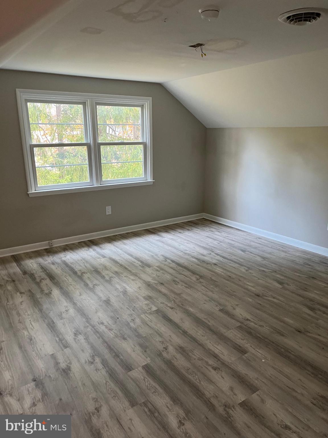 202 Museum Road Shillington, PA 19607 - Photo 21 of 29 an empty room with wooden floor and windows