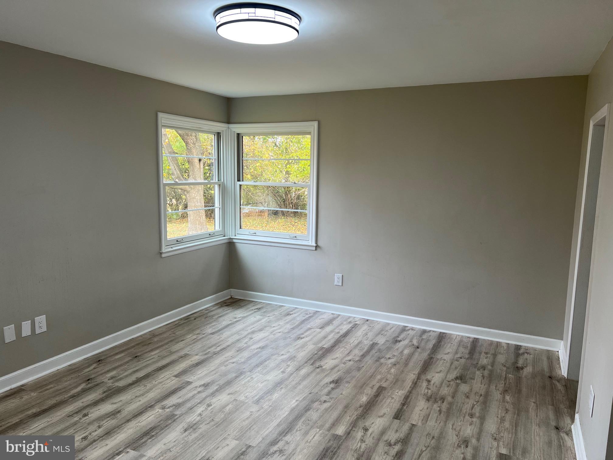 202 Museum Road Shillington, PA 19607 - Photo 23 of 29 an empty room with wooden floor and windows