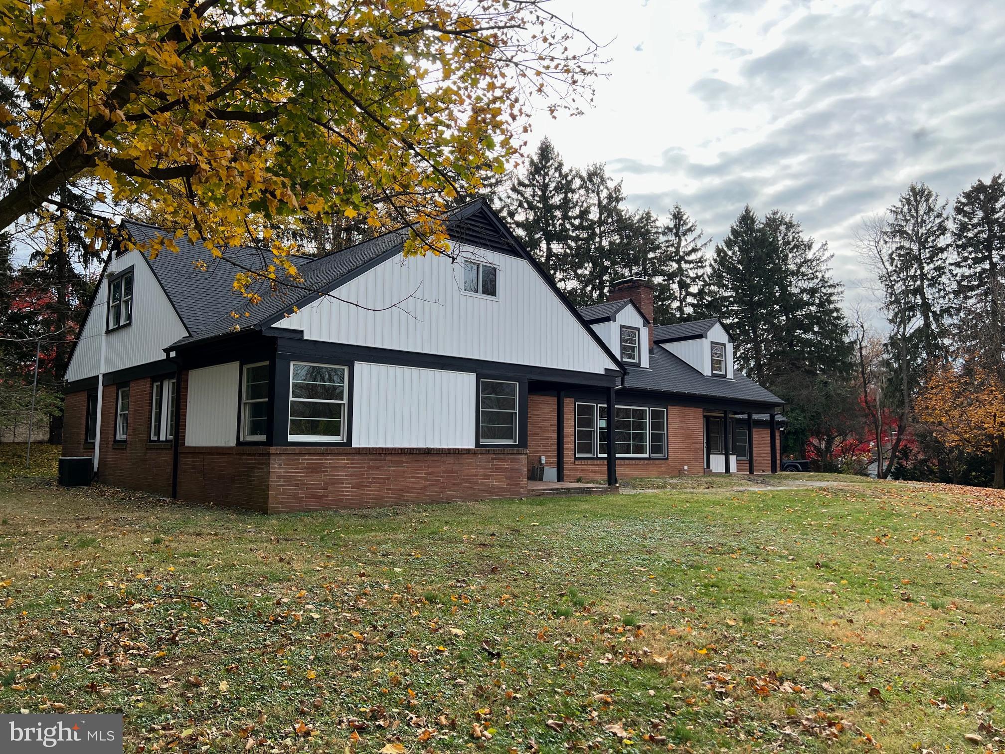 202 Museum Road Shillington, PA 19607 - Photo 4 of 29 a front view of a house with a garden and trees