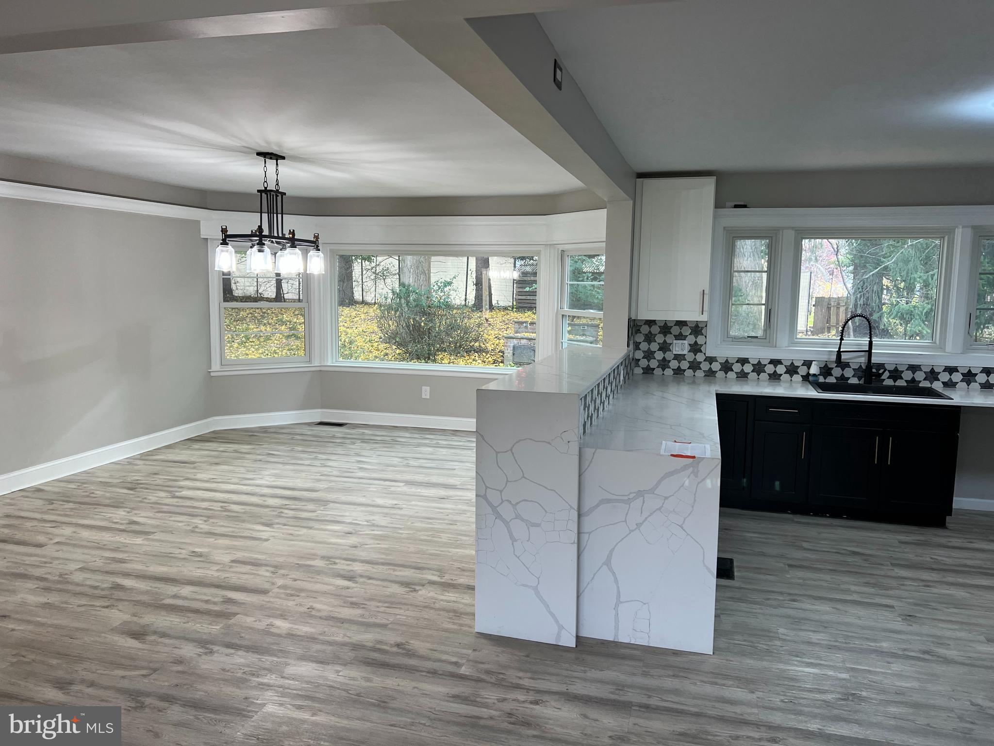202 Museum Road Shillington, PA 19607 - Photo 10 of 29 a room with kitchen island granite countertop a stove cabinets and wooden floor