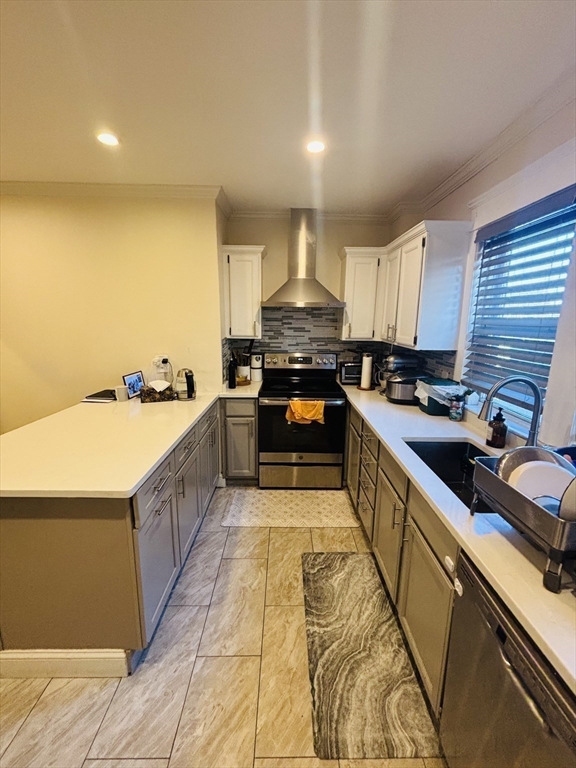 31 Garland Street, Unit 1 Chelsea, MA 02150 - Photo 6 of 9 a kitchen with stainless steel appliances granite countertop a stove a sink and a refrigerator