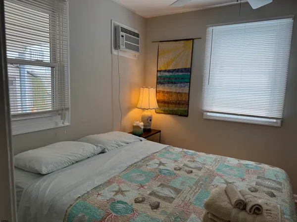 a bedroom with a bed and window