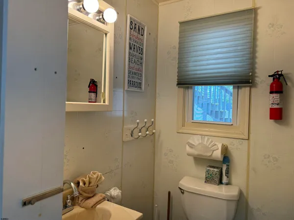 a bathroom with a toilet and a shower curtain