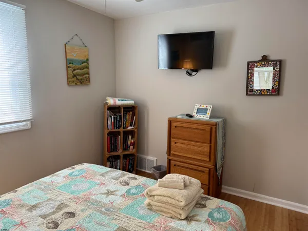 a bedroom with a bed and flat screen tv