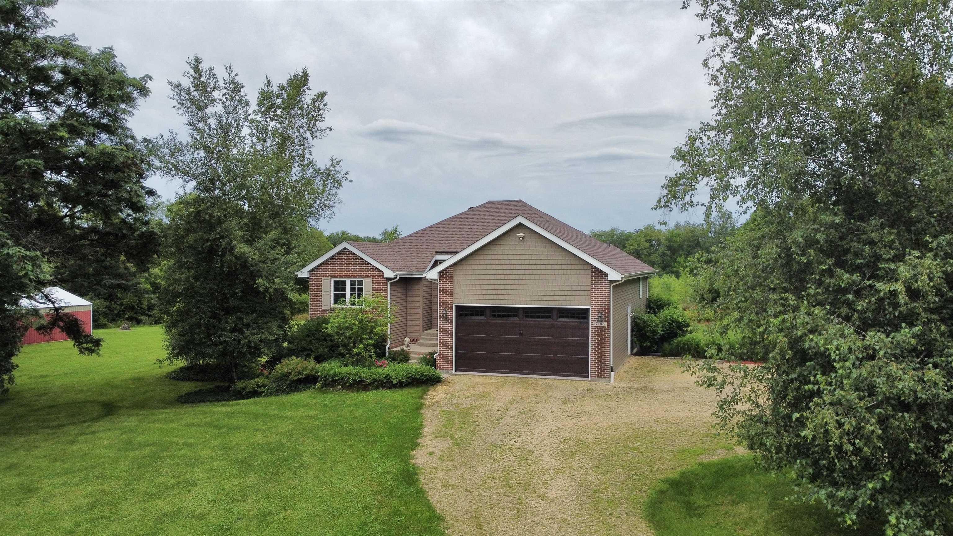 7188 Edwardsville Road Rockford, IL 61102 - Photo 1 of 73 a front view of a house with a yard and garage