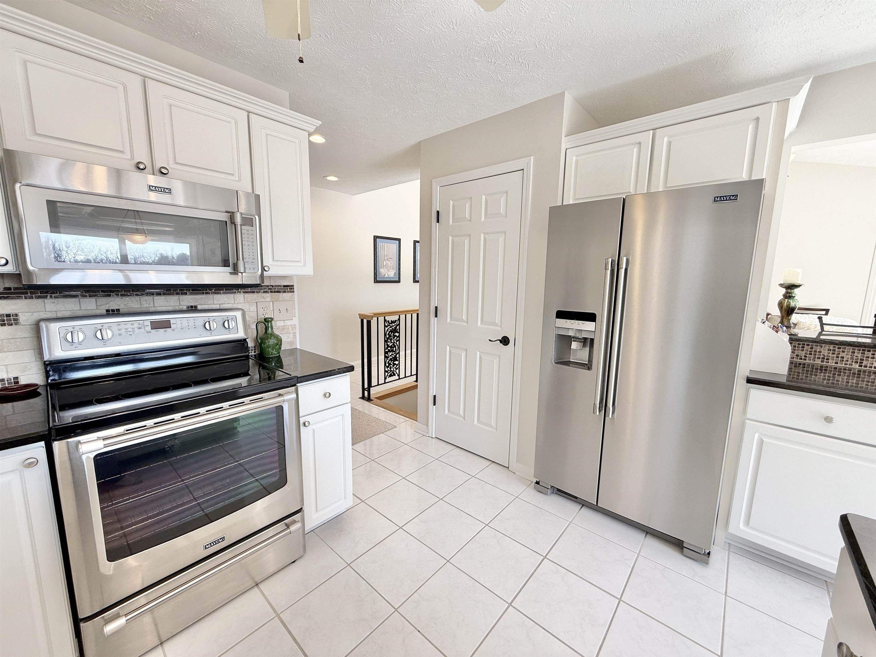 7188 Edwardsville Road Rockford, IL 61102 - Photo 22 of 73 a kitchen with stainless steel appliances a stove a microwave and a refrigerator