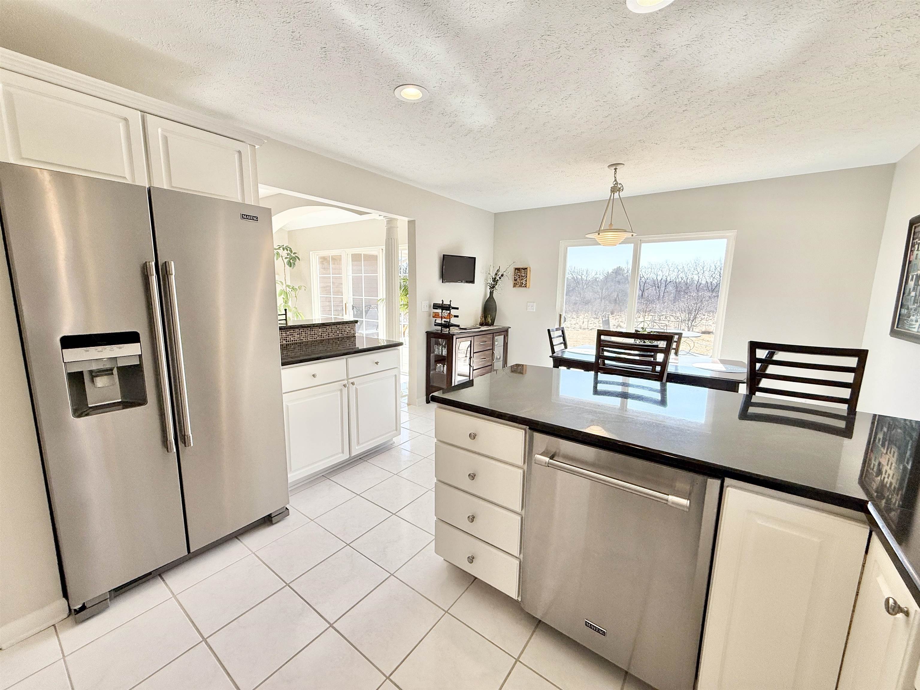 7188 Edwardsville Road Rockford, IL 61102 - Photo 23 of 73 a kitchen with stainless steel appliances a refrigerator sink and microwave