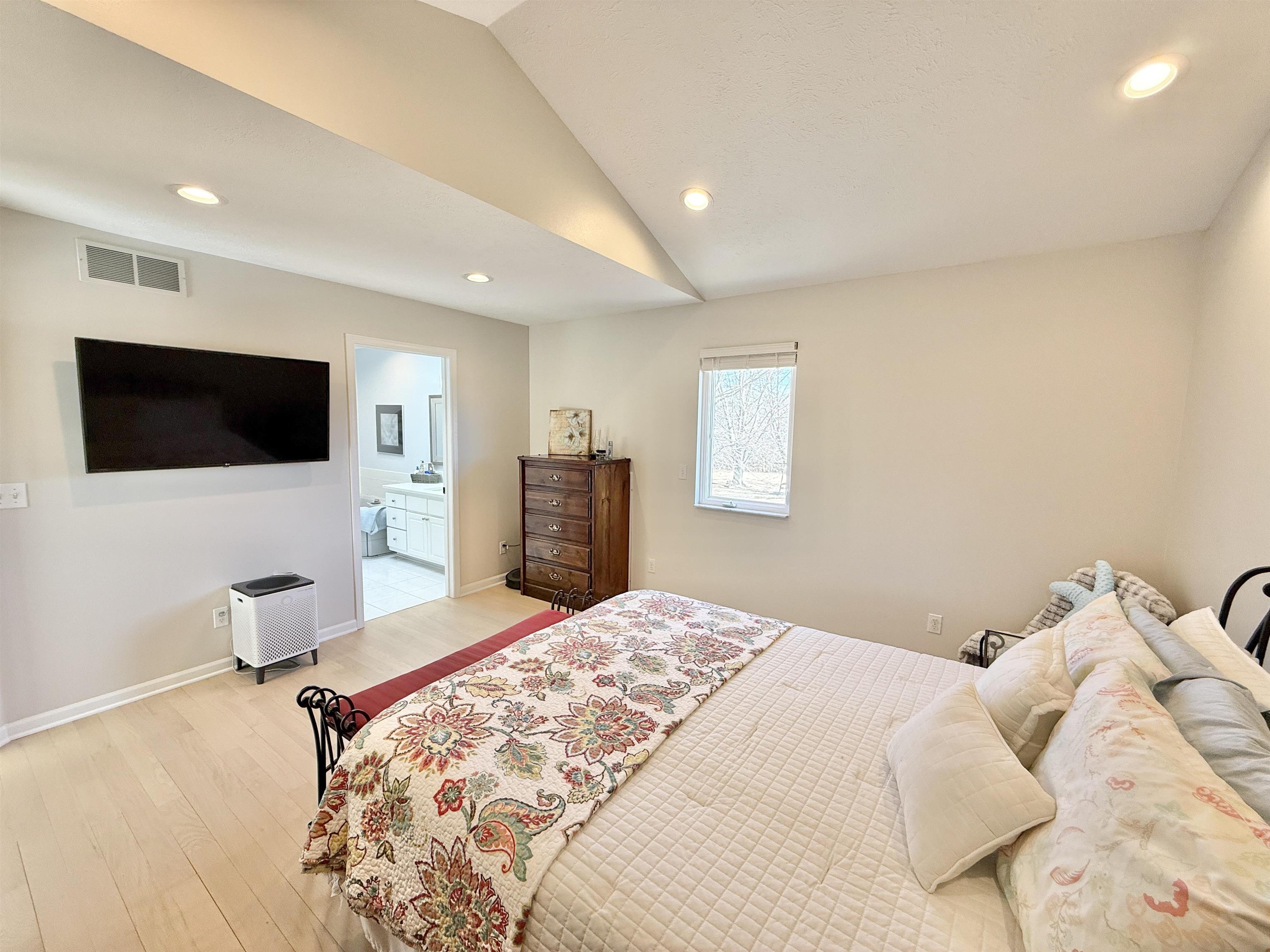 7188 Edwardsville Road Rockford, IL 61102 - Photo 29 of 73 a bedroom with a bed and a flat screen tv