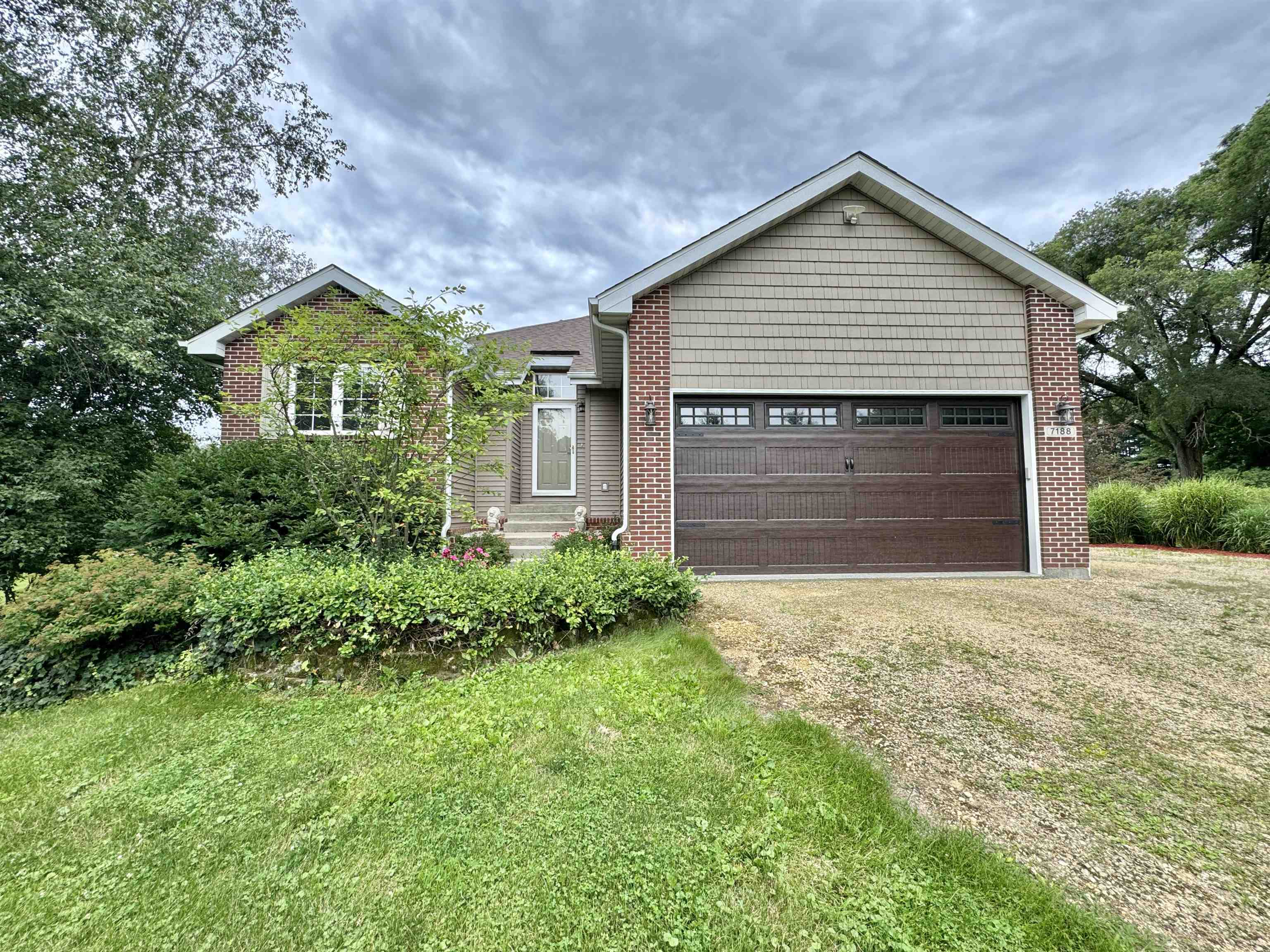 7188 Edwardsville Road Rockford, IL 61102 - Photo 3 of 73 a front view of a house with a yard and garage