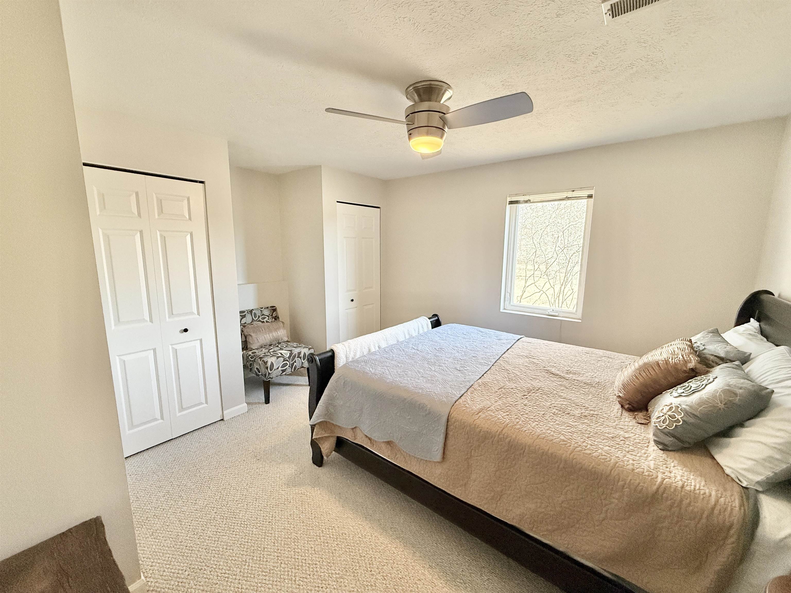 7188 Edwardsville Road Rockford, IL 61102 - Photo 45 of 73 a bedroom with a bed and a chandelier