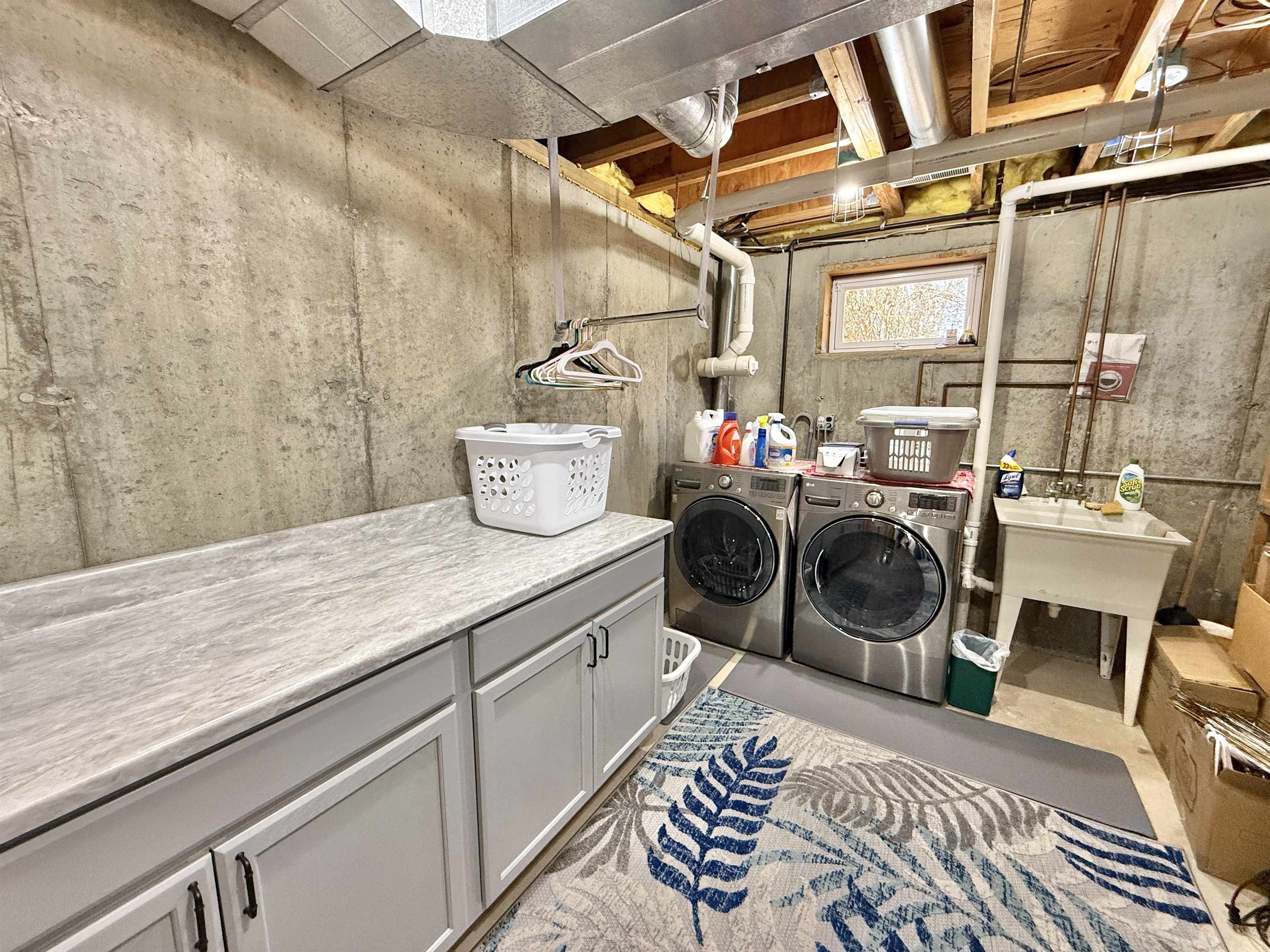 7188 Edwardsville Road Rockford, IL 61102 - Photo 46 of 73 a room with a washing machine and wooden floor