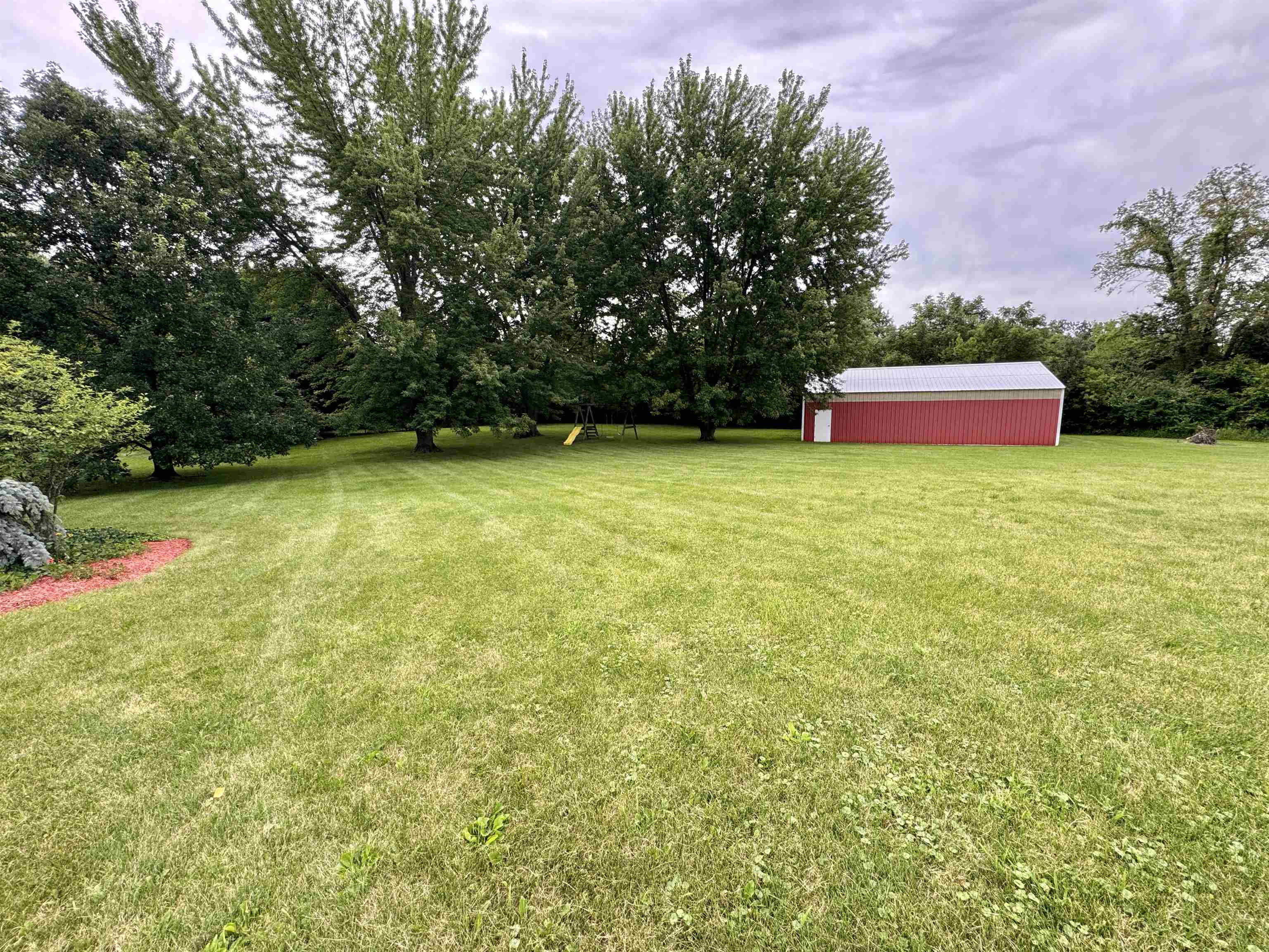 7188 Edwardsville Road Rockford, IL 61102 - Photo 57 of 73 a backyard of a house with lots of green space and fountain