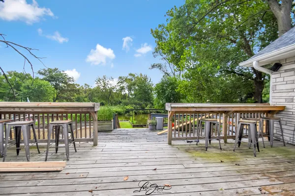 a view of a chairs and table on the wooden deck