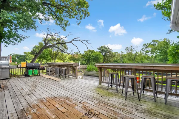 a view of a swimming pool with a patio and a yard
